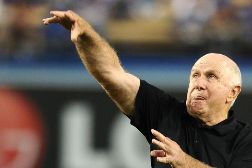 Oaks Christian football Coach Bill Redell throws out first pitch on Tuesday at Dodger Stadium.