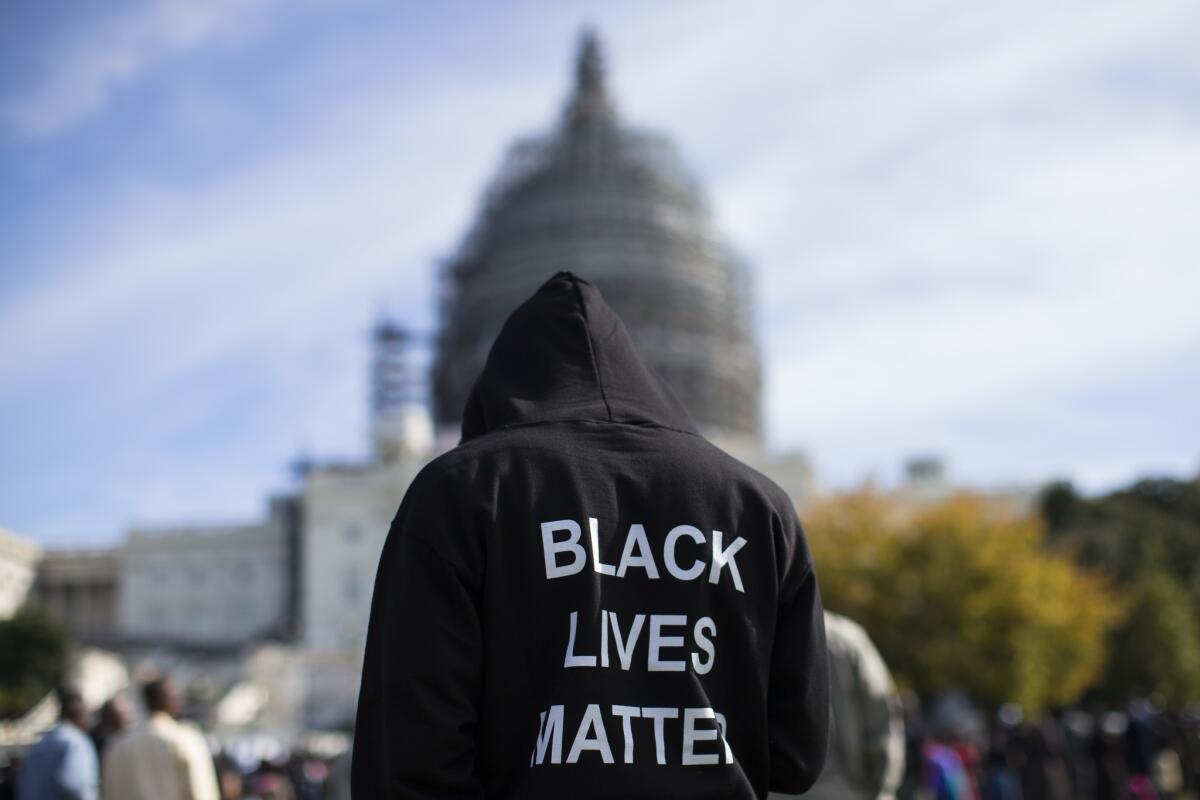 Neal Blair, of Augusta, Ga., stands on the lawn of the Capitol during an October rally to mark the 20th anniversary of the Million Man March.