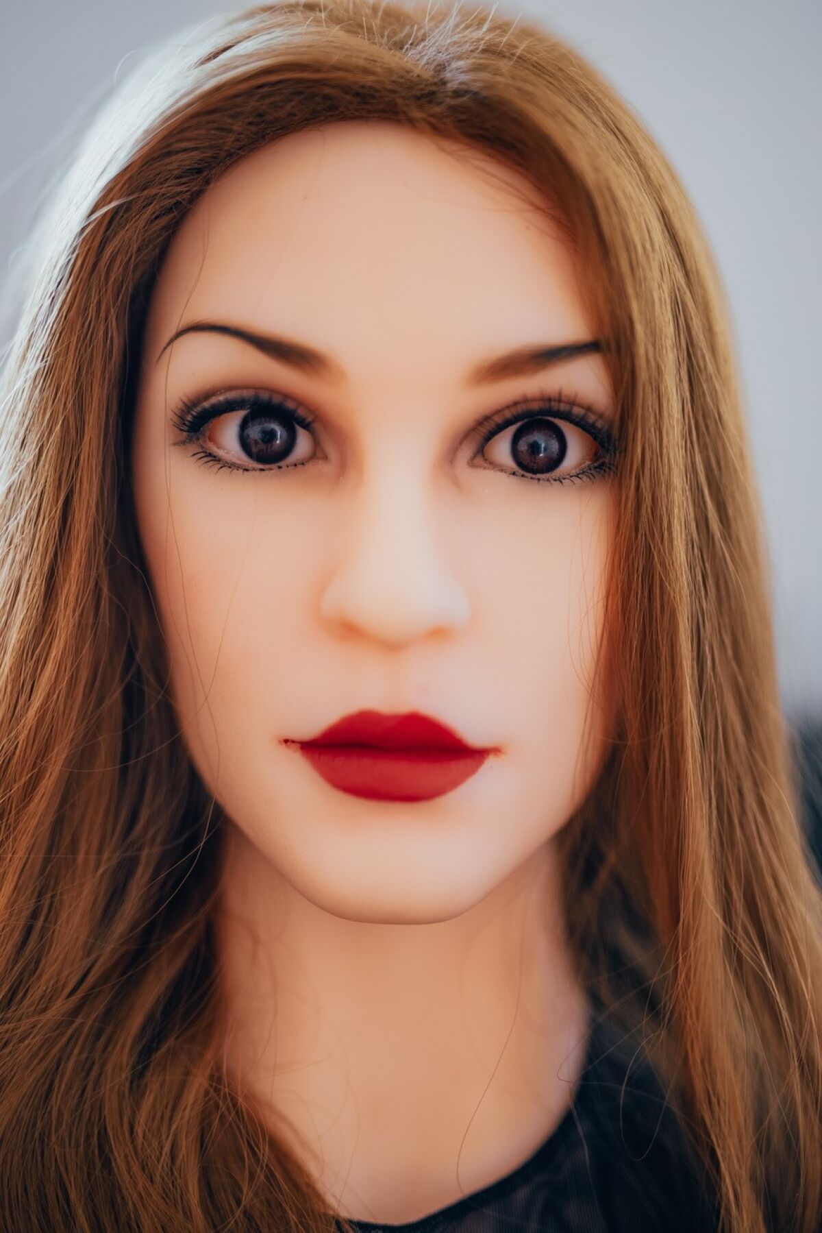 A photograph of a woman with enlarged eyes and lips.