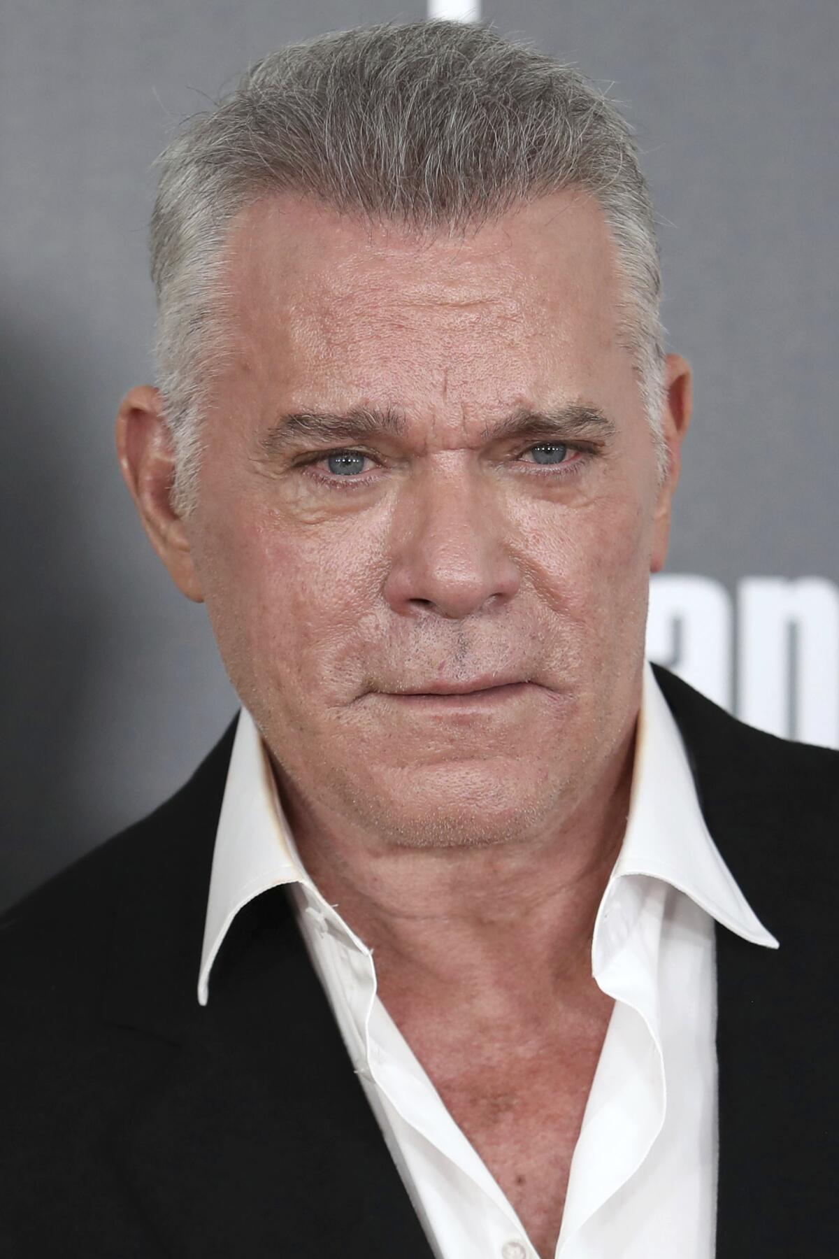 Ray Liotta in a white button-down shirt and a black blazer