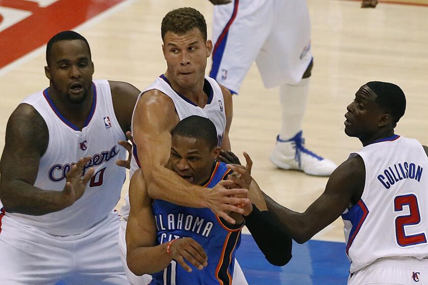 Thunder point guard Russell Westbrook is hit in the head by Clippers power forward Blake Griffin after driving into the lane and making a pass in the second half.