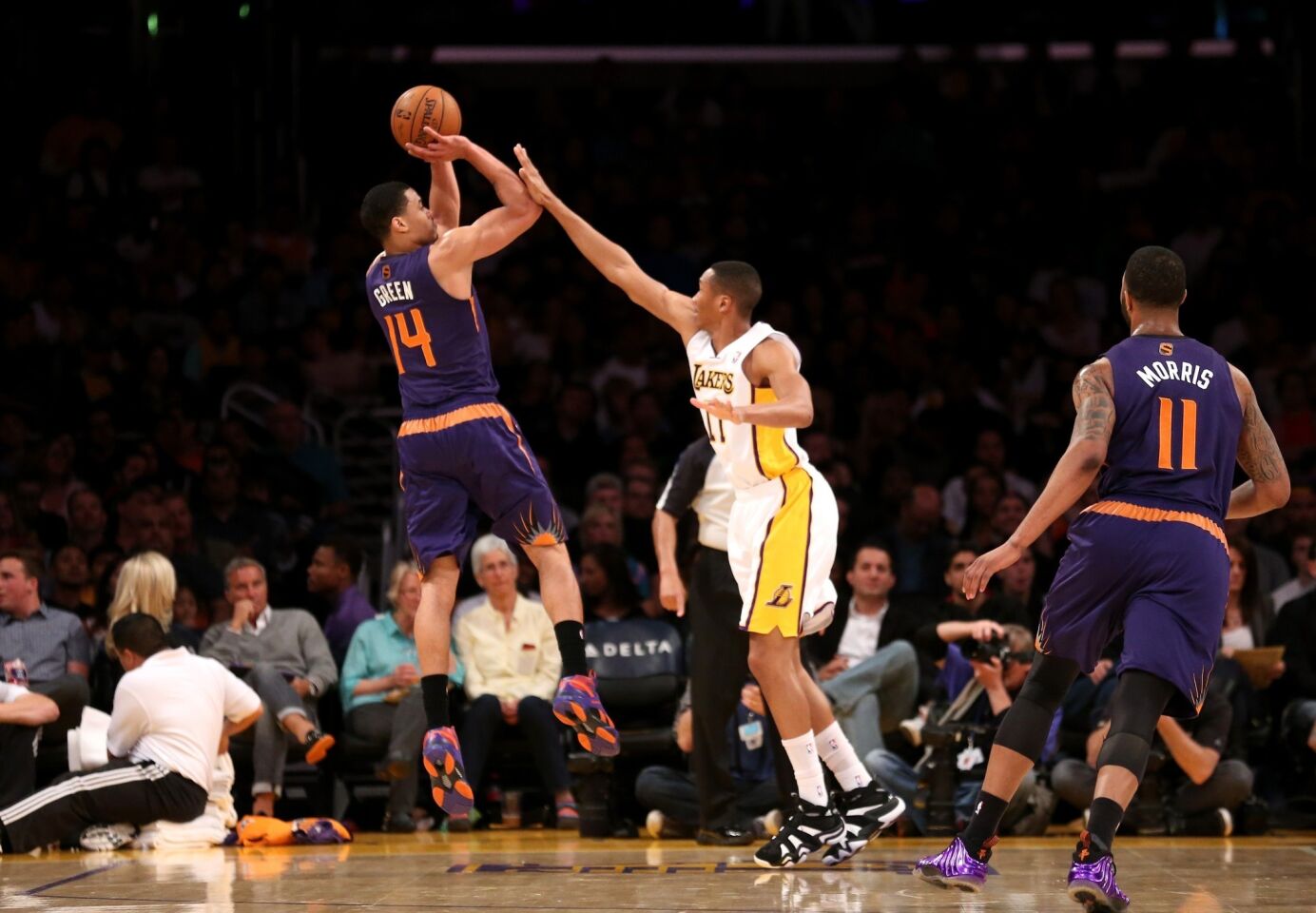 Phoenix Suns guard Gerald Green, left, shoots over Lakers small forward Wesley Johnson during the first half of Sunday's game at Staples Center.