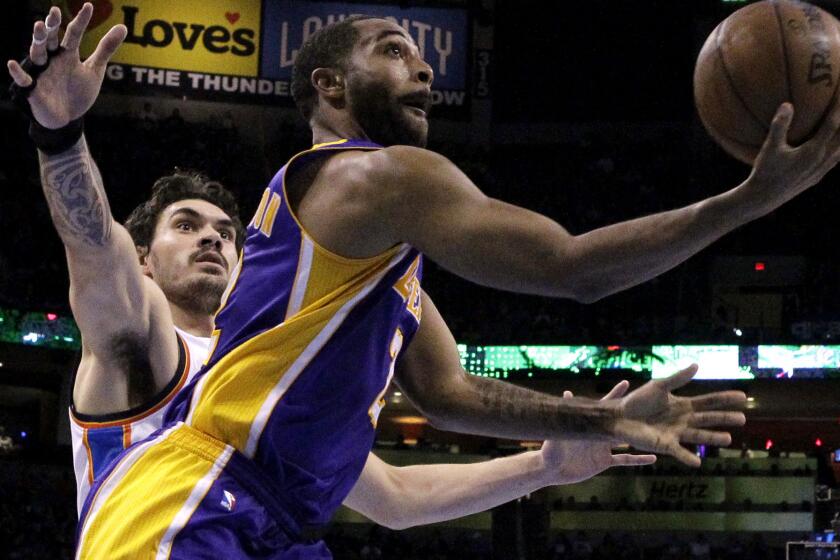 Lakers guard Wayne Ellington slips past Thunder center Steven Adams on March 24.