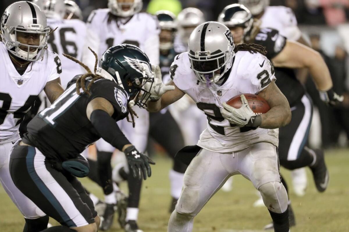 Raiders running back Marshawn Lynch carries the ball against the Eagles during a game on Christmas Day.