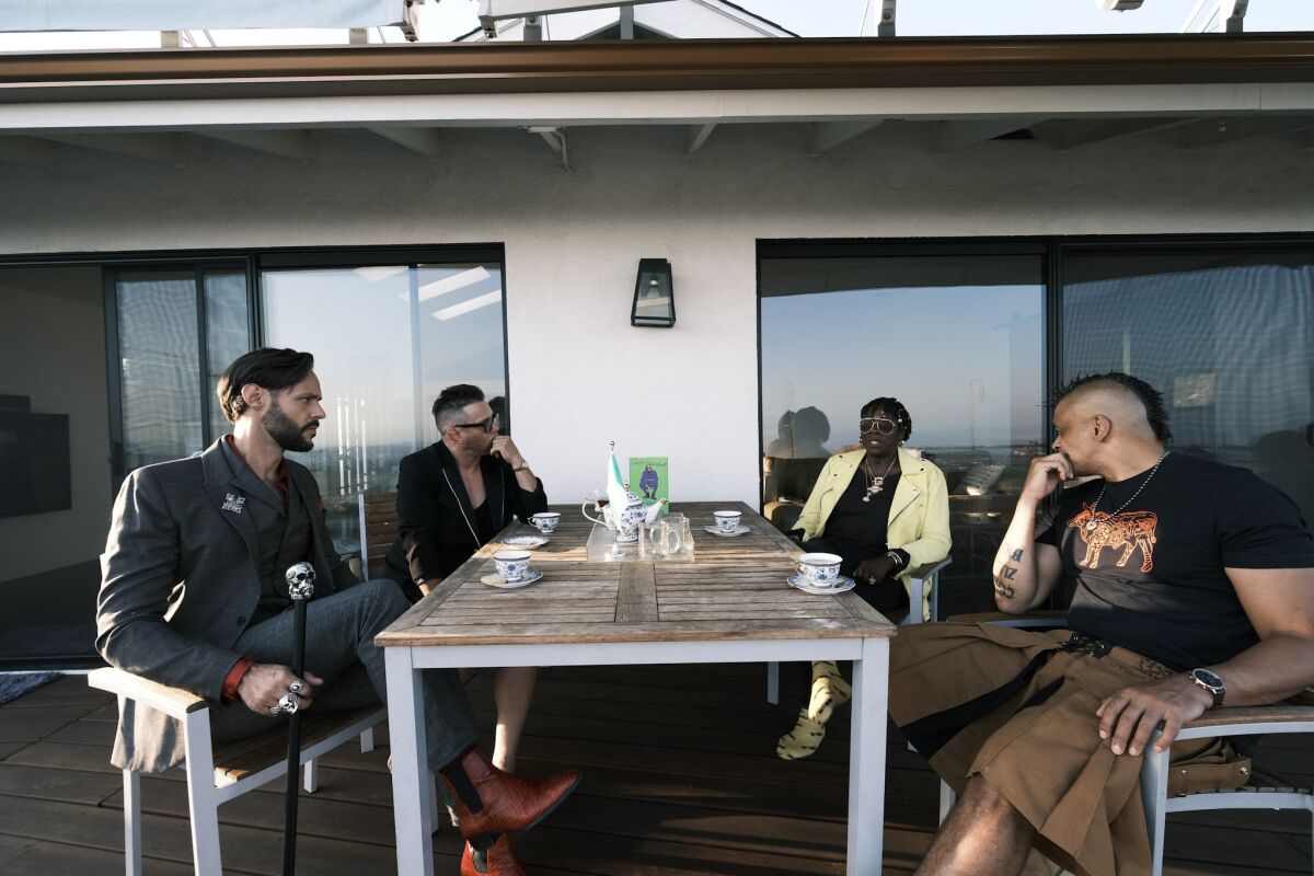 Leach, Graham, Yashere and Tonderai sitting in the backyard at Yashere's home.