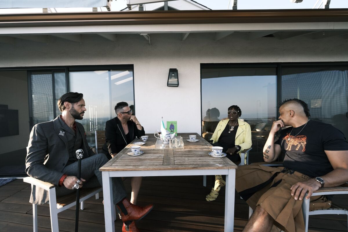 Leach, Graham, Yashere and Tonderai  sitting in the backyard at Yashere's home.