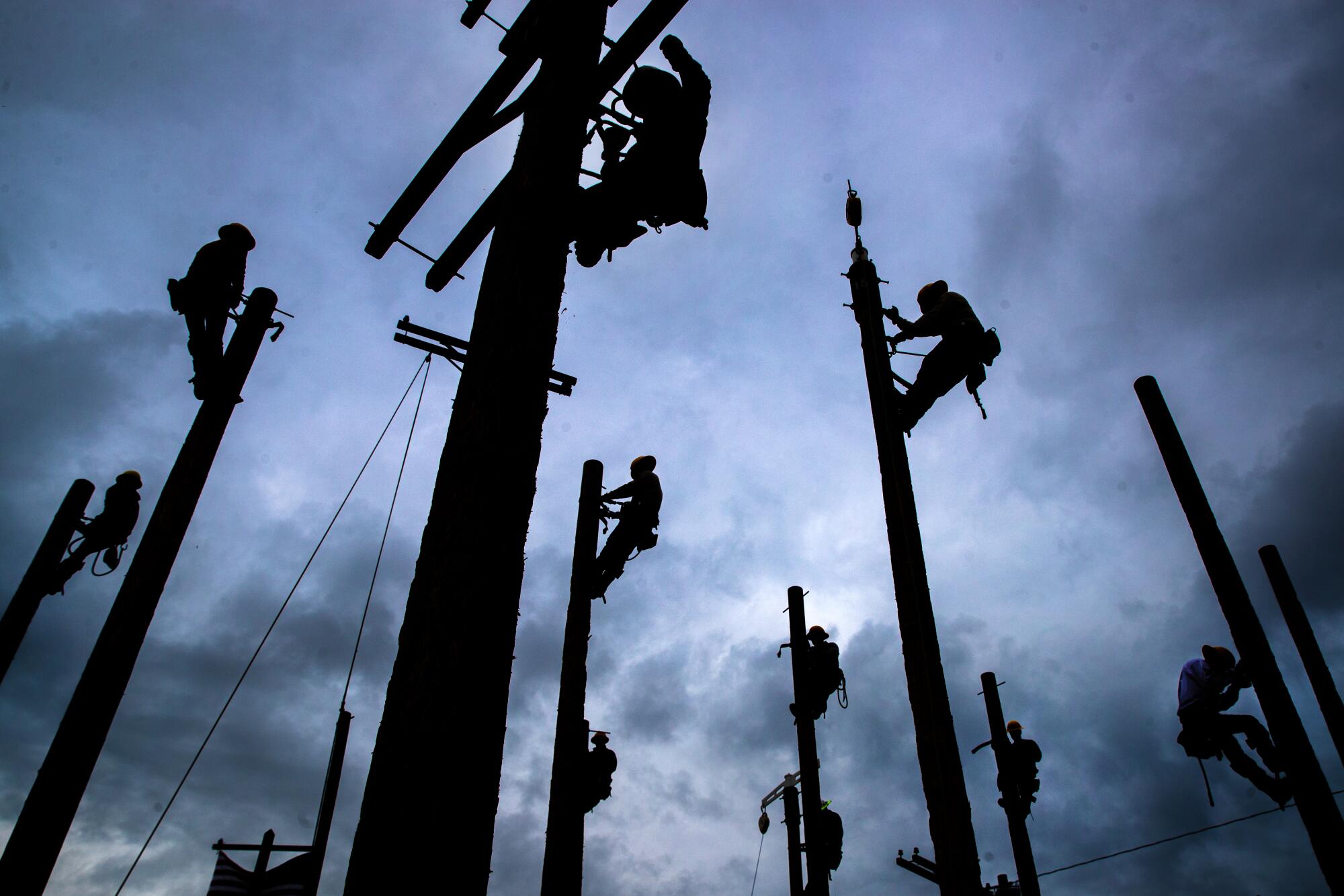 Students practice pole climbing at Los Angeles Trade-Technical College.
