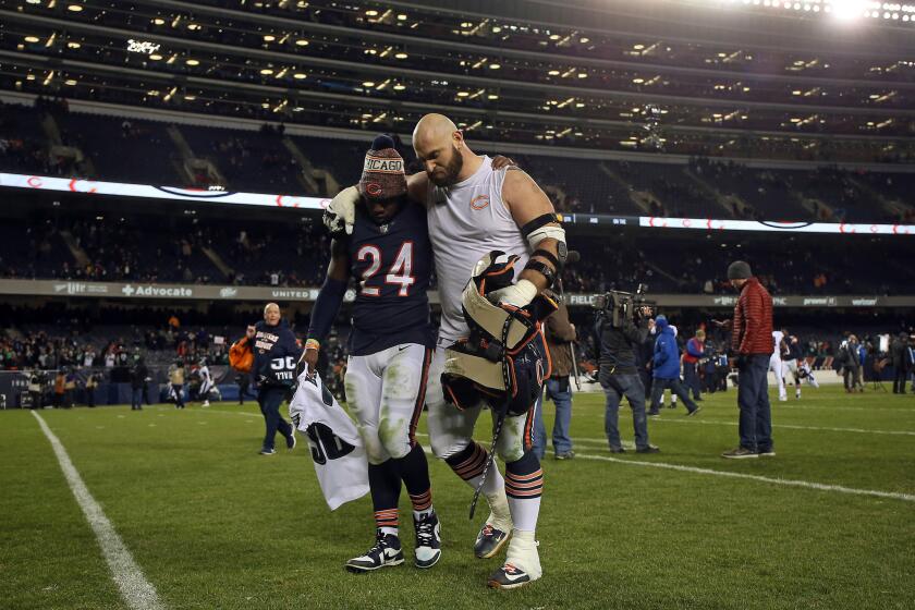 Bears running back Jordan Howard, left, and lineman Kyle Long walk off together after a playoff loss to the Eagles on Jan. 6, 2019, at Soldier Field.