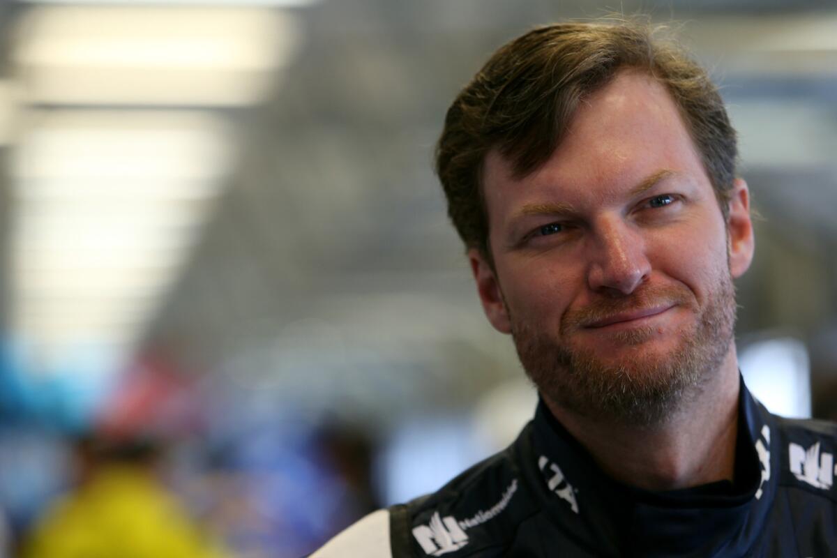 Dale Earnhardt Jr., driver of the #88 Nationwide Chevrolet, stands in the garage area during practice for the NASCAR Sprint Cup Series Quaker State 400 at Kentucky Speedway on July 8.