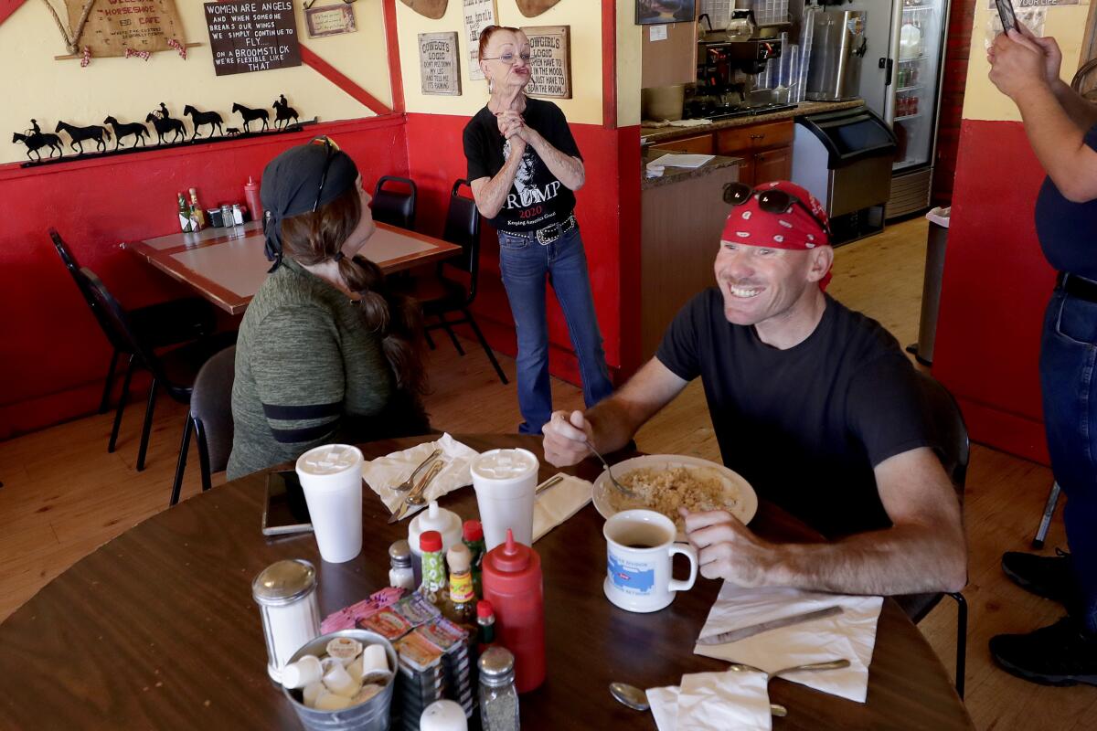 Customers cheer Debbie Thompson, owner of the Horseshoe Cafe in Wickenburg, Ariz.