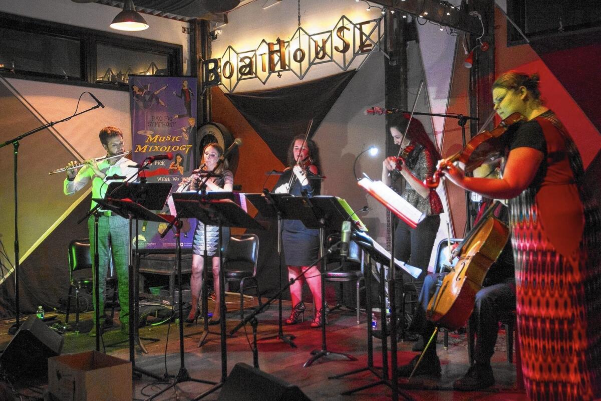 Members of the Pacific Symphony perform during "Music Mixology" at the Boathouse Collective in Costa Mesa on Thursday. Flutist Benjamin Smolen describes the event as "your local symphony orchestra meets your local pub trivia night."