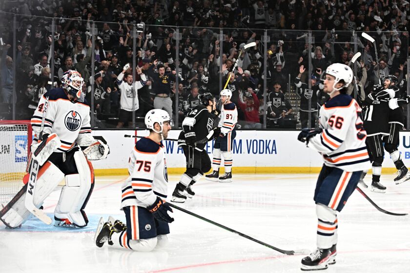  Kings players celebrate the tying goal against the Oilers late in the third period in game six