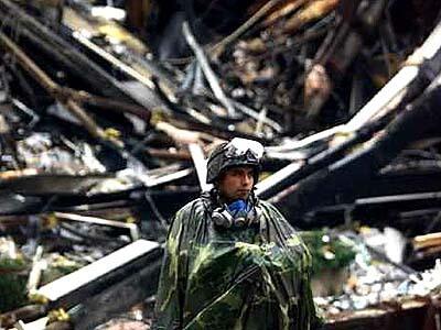 A National Guardsman watches over part of the damage to the WTC