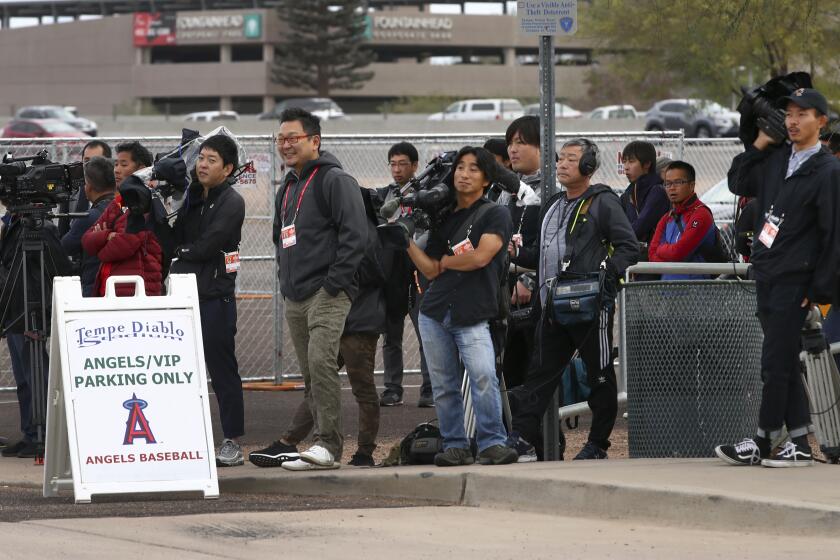 Members of the media await the arrival of Los Angeles Angels baseball player Shohei Ohtani at Tempe Diablo Stadium on Tuesday, Feb. 13, 2018, in Tempe, Ariz. (AP Photo/Ben Margot)