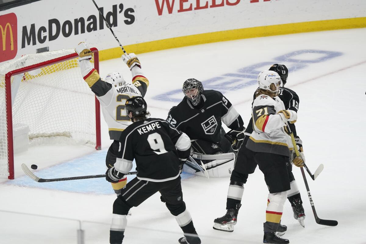 Kings goalie Jonathan Quick, center, gives up a goal to the Golden Knights' William Karlsson (71) on March 19, 2021.