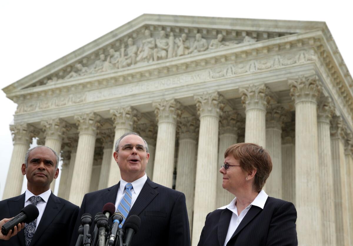 Aereo CEO Chet Kanojia, left, stands alongside outside counsel David Frederick and general counsel Brenda Cotter in front of the U.S. Supreme Court earlier this year.