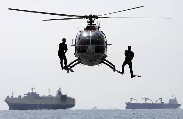 Philippine coast guard divers jump from a helicopter hovering over the ocean during a drill at the ASEAN Regional Forum in Manila, Philippines. The drill involved a mock disaster to test the capability of Asian Pacific countries to respond to a deadly supertyphoon.