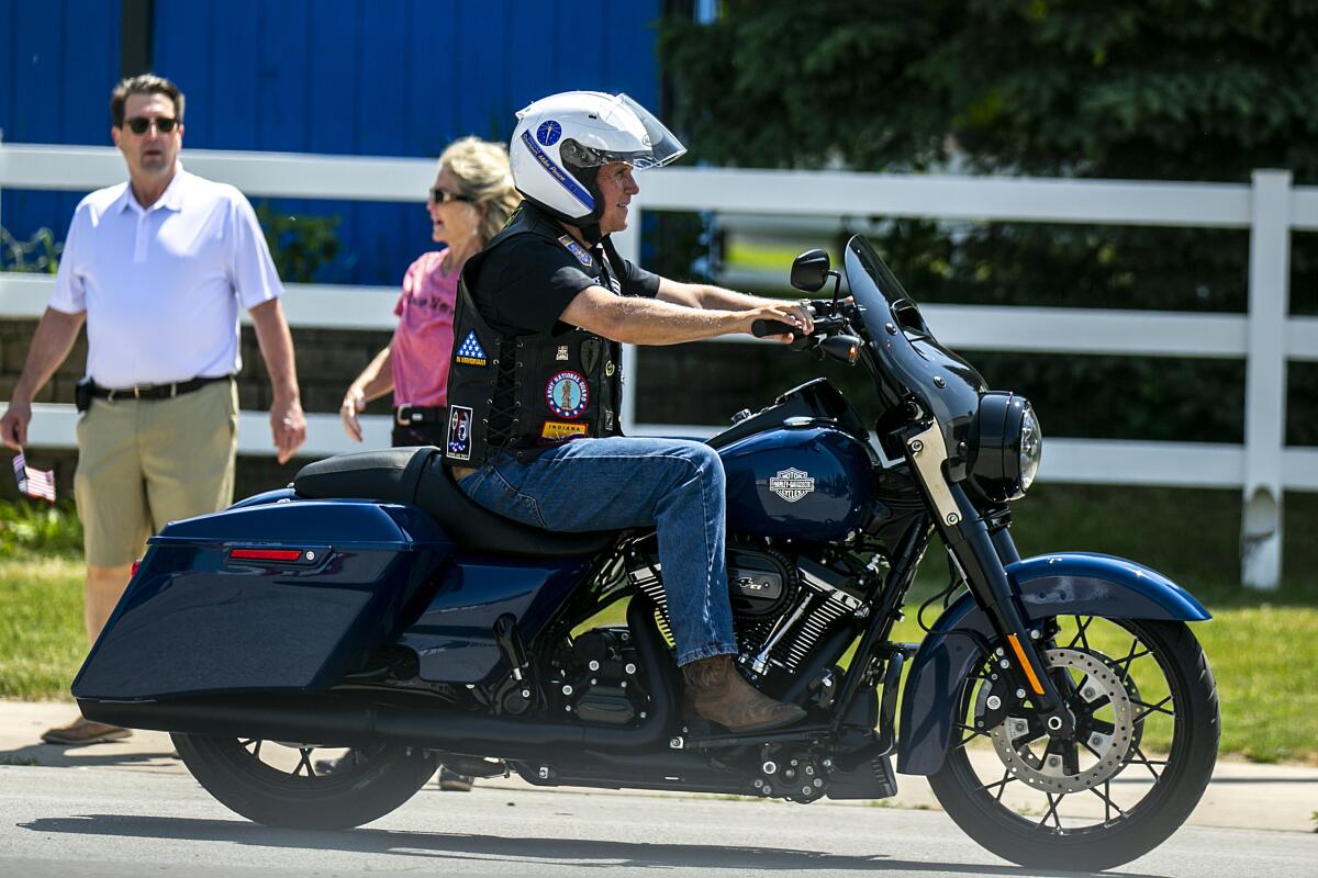 Former Vice President Mike Pence rides a motorcycle during U.S. Sen. Joni Ernst's "Roast and Ride" in Des Moines.