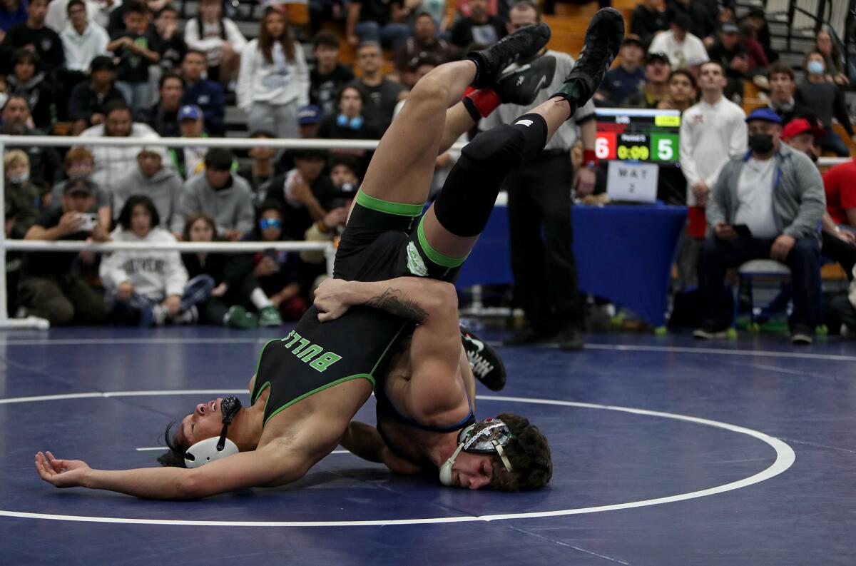 Fountain Valley's Zach Parker, right, wrestles SLAM's Kasius Graham in the 145-pound final of the Five Counties Tournament.