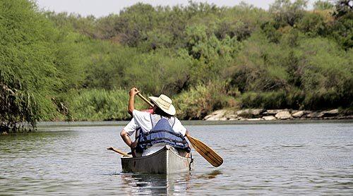 Avid bird watchers John Odgers and Betty Perez take to the Rio Grande at the Texas-Mexico border near Roma, Texas.