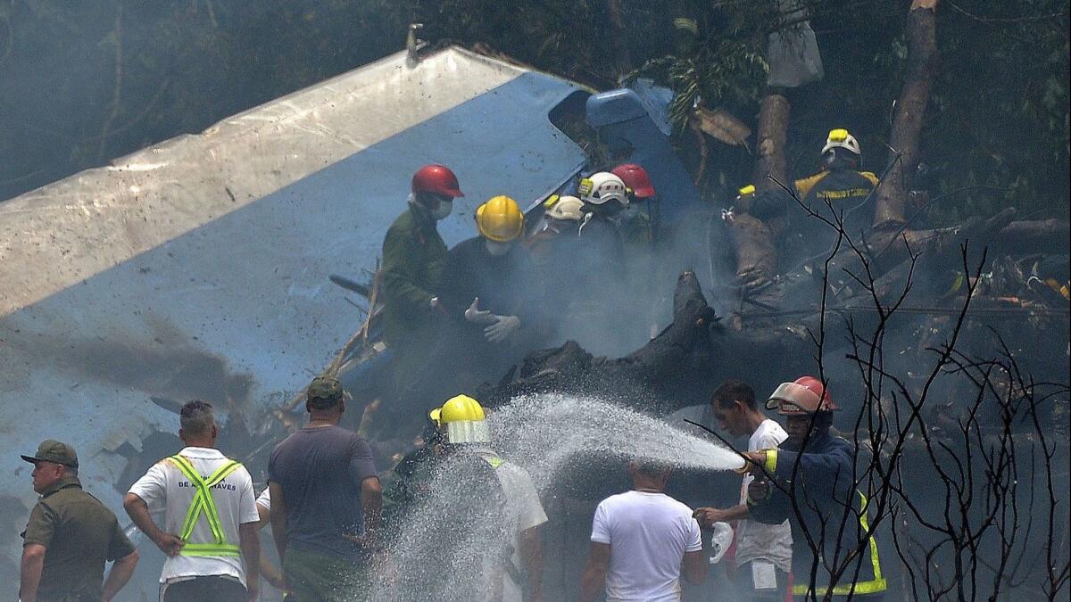 Emergency personnel work at the scene of the crash of an airliner that went down soon after takeoff from Havana's international airport.