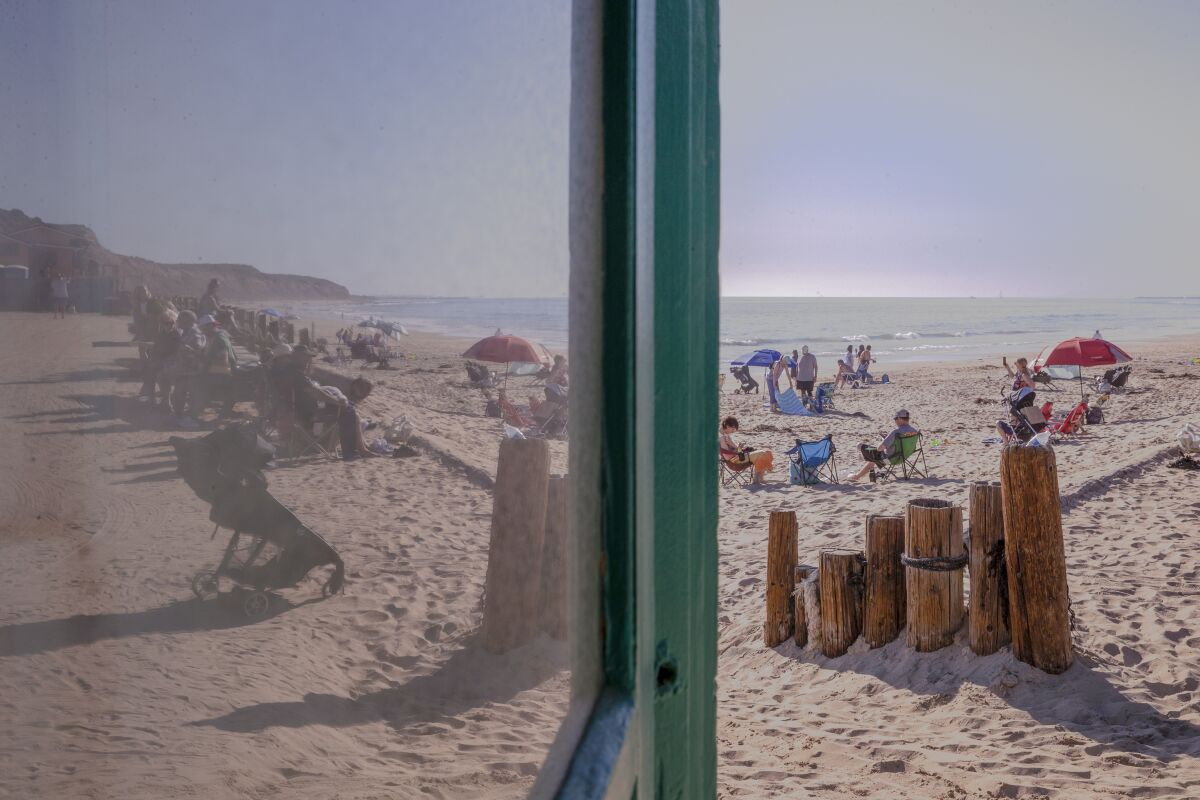A beach view reflected in a window.