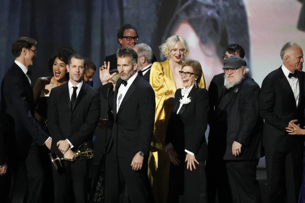 David Benioff onstage with the "Game of Thrones" cast and creative team after the show won outstanding drama series at the 70th Primetime Emmy Awards.