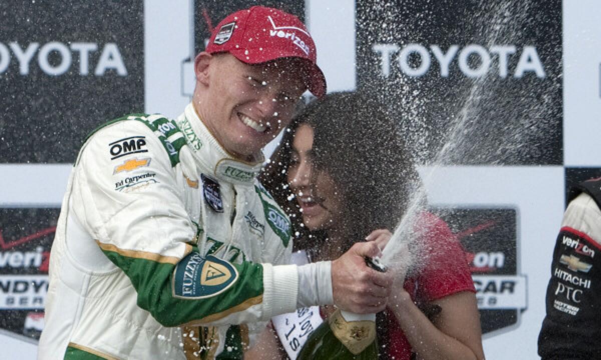 IndyCar Series driver Mike Conway celebrates on the podium after winning the Toyota Grand Prix of Long Beach on Sunday.