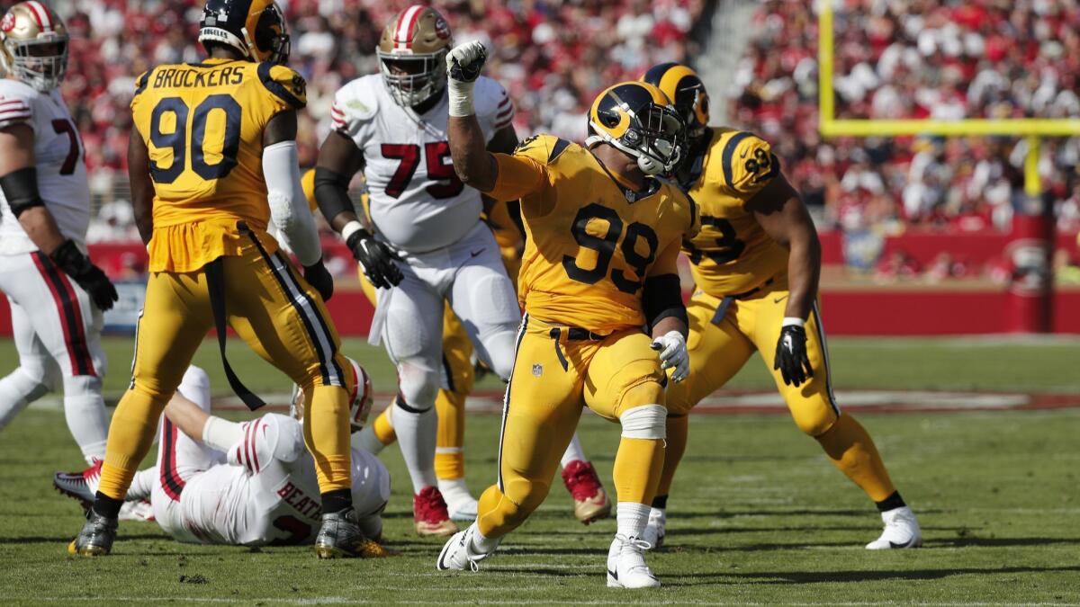 Rams defensive tackle Aaron Donald (99) reacts after sacking San Francisco 49ers quarterback C.J. Beathard (3) in the first half at Levi's Stadium on Sunday in Santa Clara.