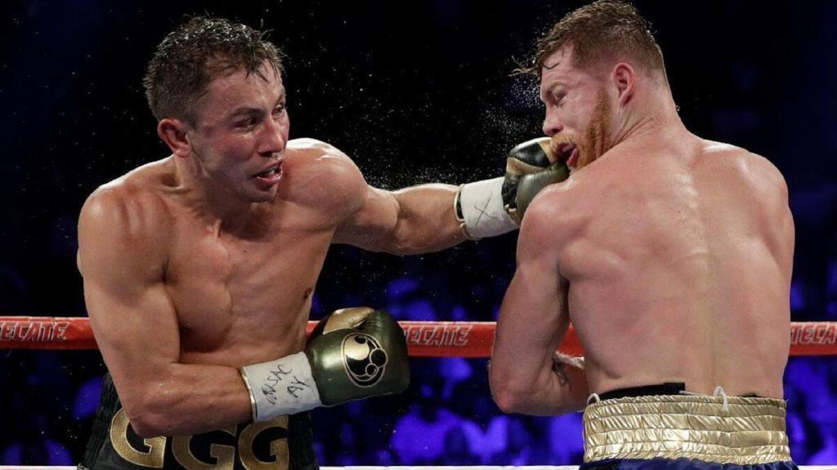 Gennady Golovkin, left, connects with a left to Canelo Alvarez during their middleweight title fight in Las Vegas on Sept. 17, 2017.