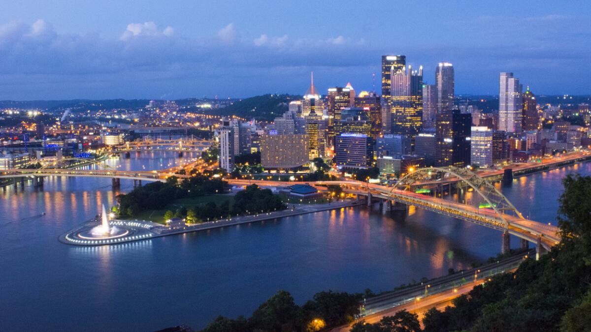 The Pittsburgh skyline is shown at night. American and Southwest are offering $278 round-trip fares to the city from LAX.