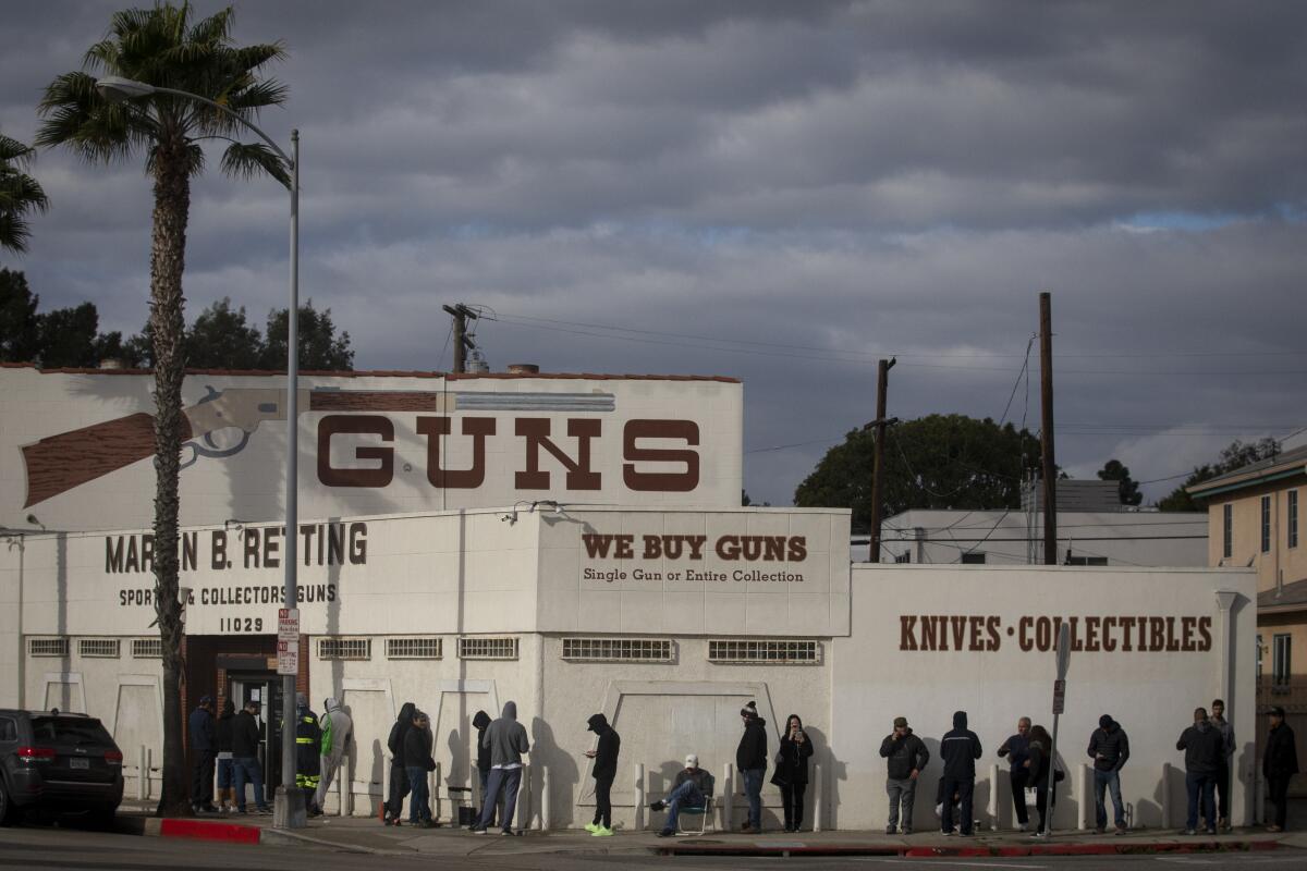 The line to get into a Culver City gun store extends around the corner on March 15, 2020.