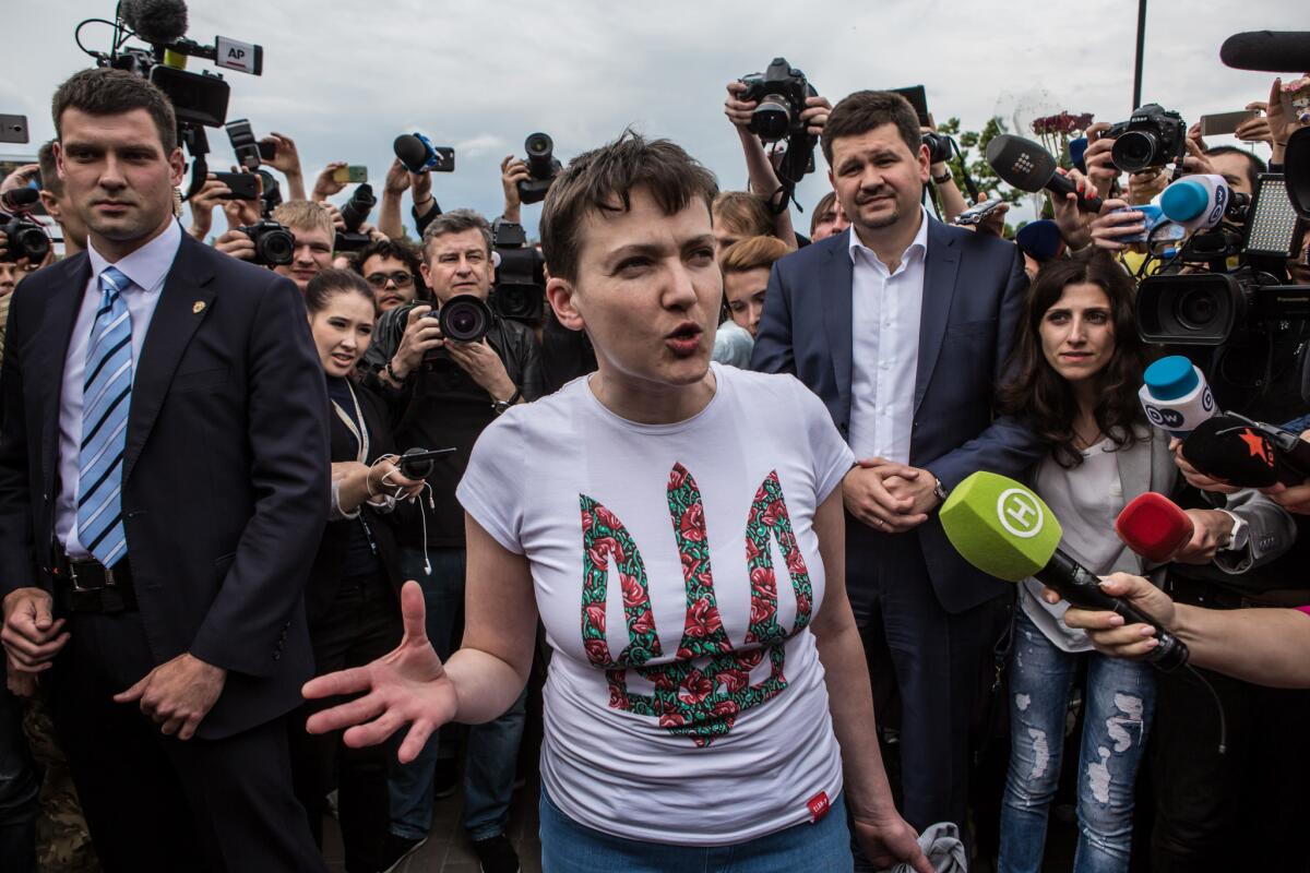 Ukrainian military pilot Nadiya Savchenko is surrounded by media upon her arrival Wednesday in Boryspil, Ukraine.
