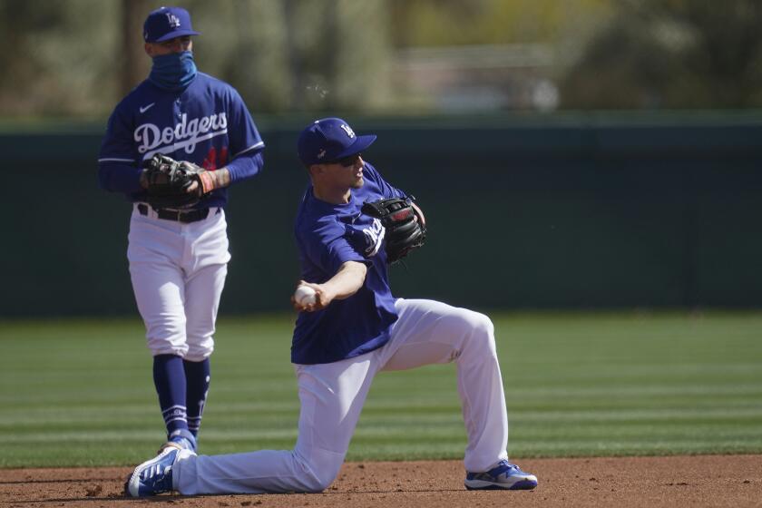Los Angeles Dodgers shortstop Corey Seager, right, throws to second base as Dodgers infielder Omar Estevez.