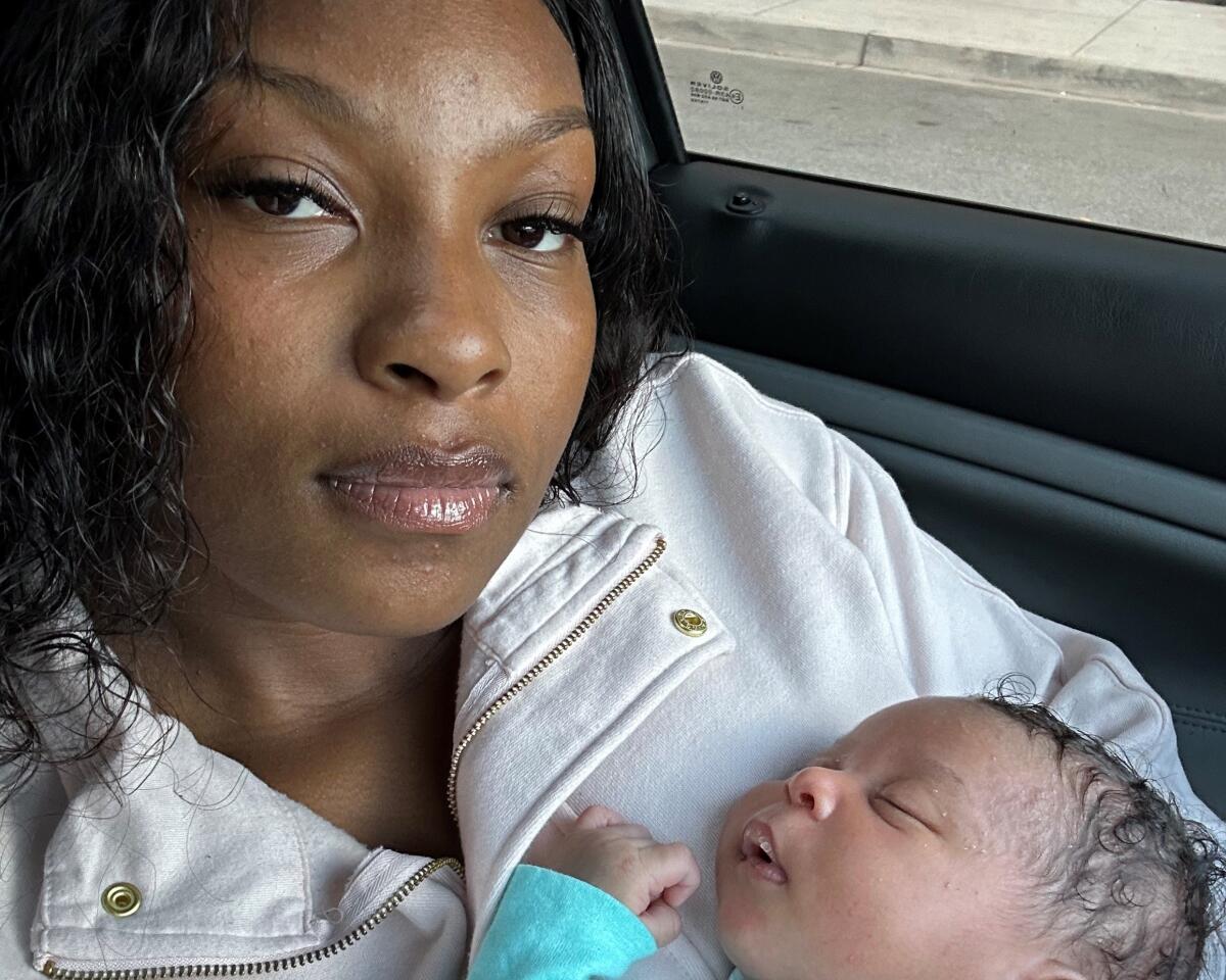 A woman cradles her newborn. 