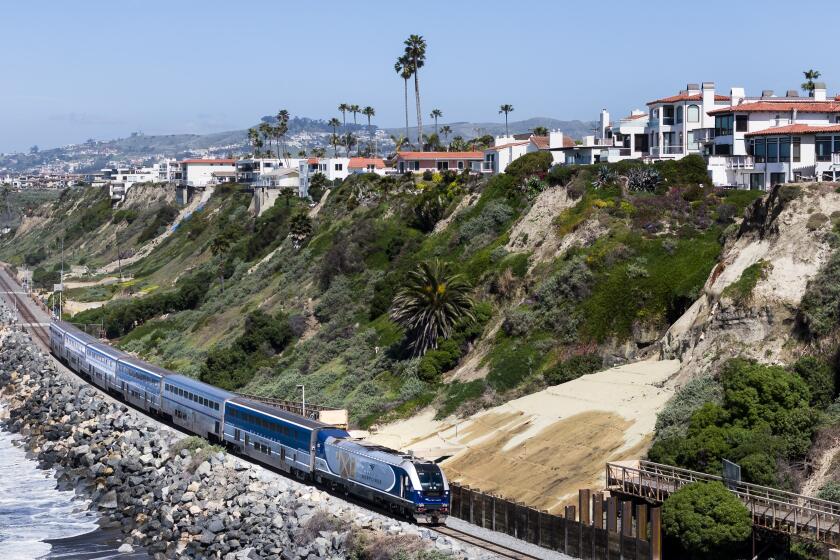 An Amtrak Pacific Surfliner train travels south through San Clemente, CA at Mariposa Point on Monday, March 25, 2024 following a nearly two-month closure due to landslides. A 200-foot-long wall was built after a landslide took out part of a pedestrian bridge and sent dirt and debris onto the tracks. (Photo by Paul Bersebach, Orange County Register/SCNG)