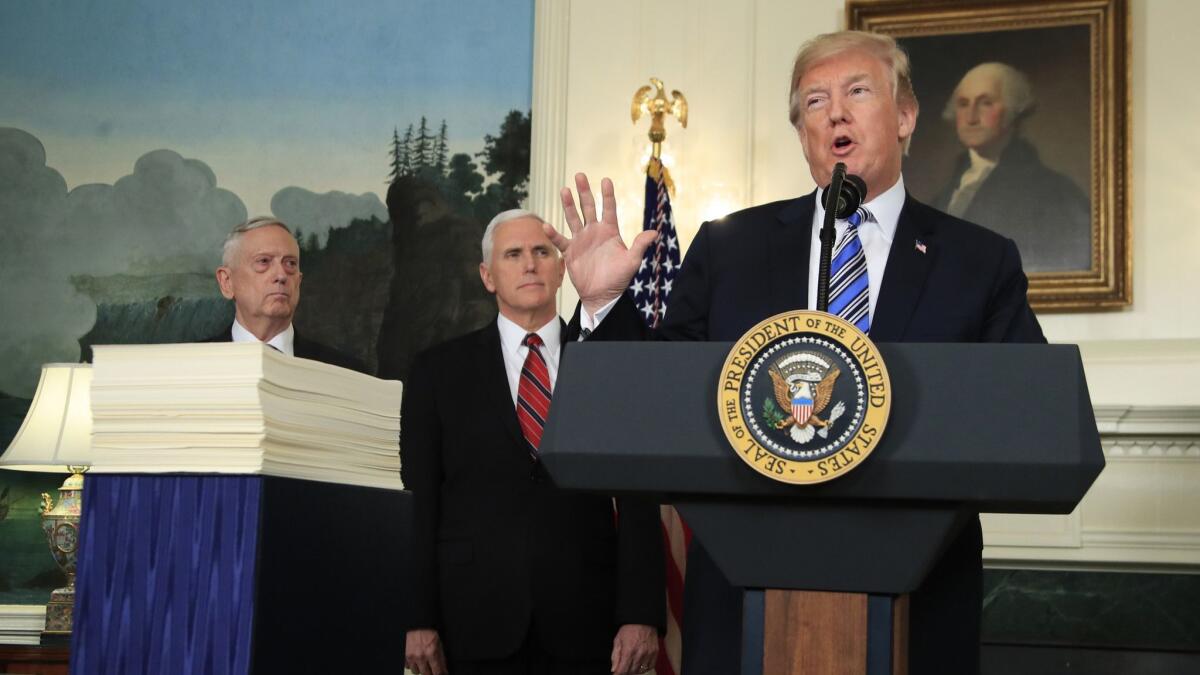President Trump, with Defense Secretary James N. Mattis, left, and Vice President Mike Pence, announces in March his signing of a $1.3-trillion spending bill.