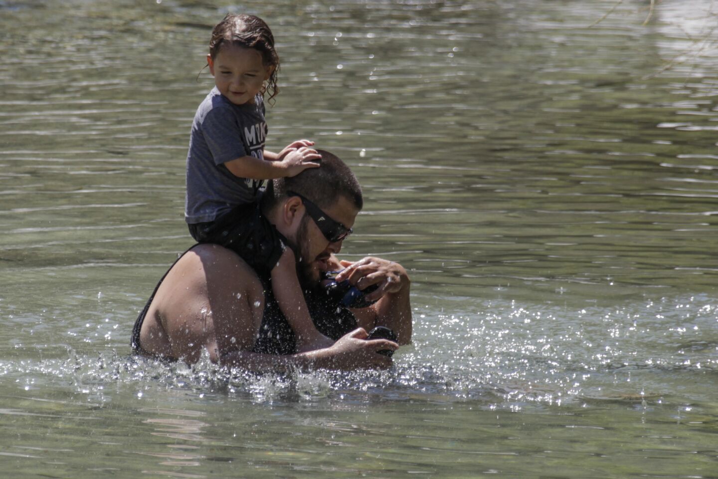Josh Navarro and niece Frankie, 2, enjoy Lyle Creek in San Bernardino.
