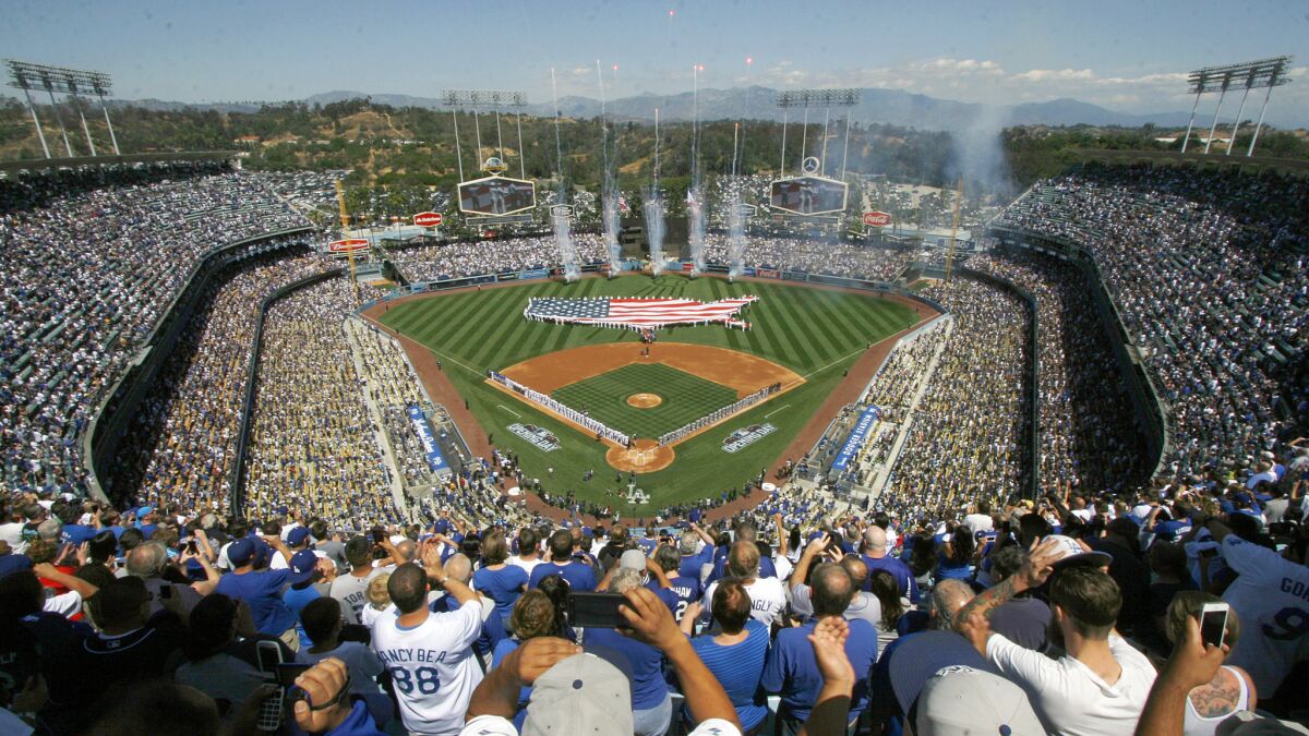 Fans cheer during opening day ceremonies before the Dodgers and San Diego Padres play at Dodger Stadium.