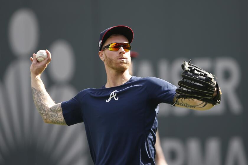 Atlanta Braves starting pitcher Mike Foltynewicz (26) throws in the outfield during a team workout Tuesday, Oct. 8, 2019, in Atlanta. Foltynewicz is scheduled to start for the Braves when face the St. Louis Cardinals in Game 5 of the NLCS Wednesday in Atlanta. (AP Photo/John Bazemore)