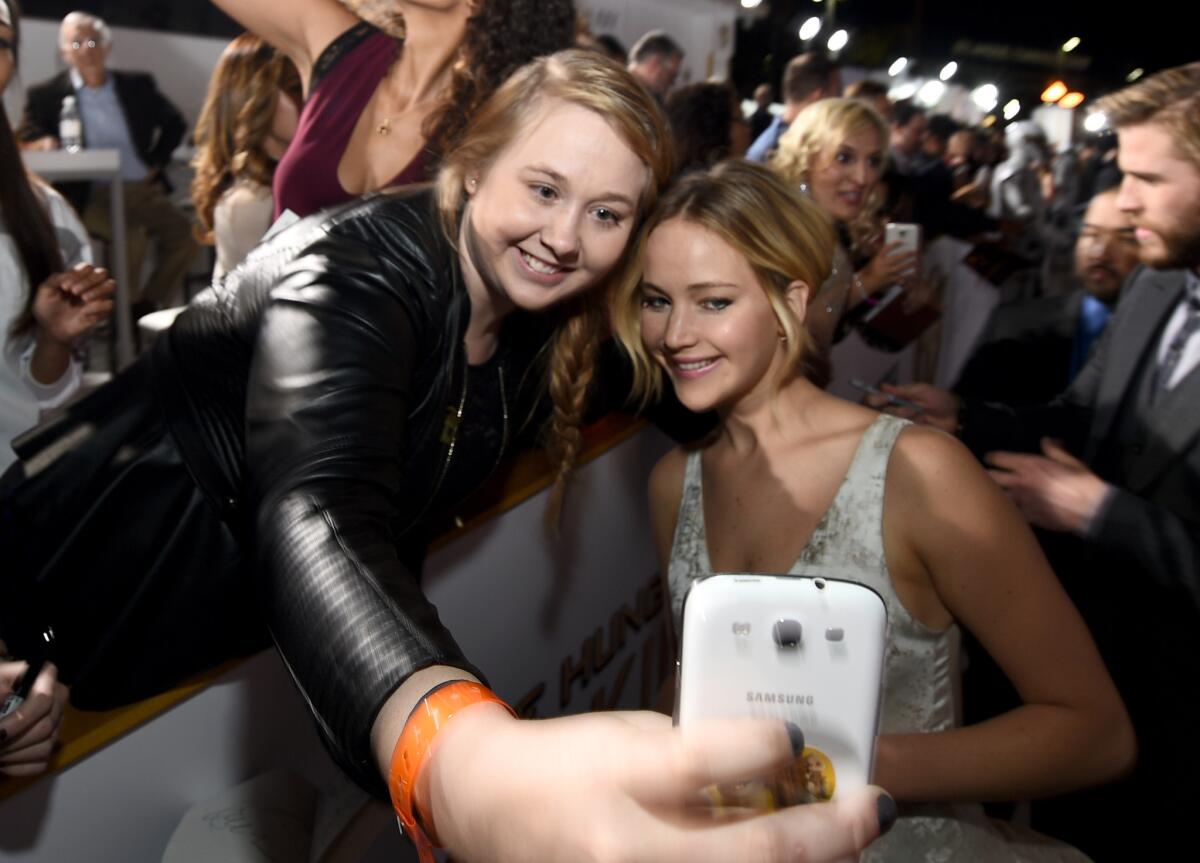 Fan Chelsea Boyce, left, takes a selfie with actress Jennifer Lawrence on Nov. 17 at a Los Angeles event celebrating the release of "The Hunger Games: Mockingjay - Part 1." Lawrence was one of dozens of actresses whose more intimate selfies and photos were made public by hackers earlier in 2014.