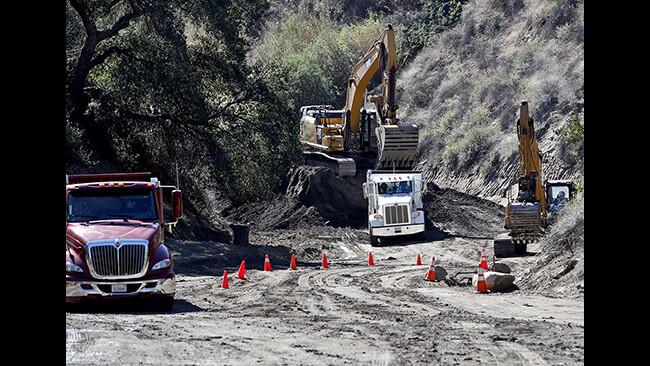 The mud and debris collected from the recent storm and flash flood at the Lower Sunset Debris Basin on Country Club Drive is being removed in Burbank, on Thursday, Feb. 8, 2018. The debris basin received about 20% of its capacity during the storm. About 600 truck loads of debris have been taken away so far. The debris is being taken to and taken to am L.A. County dump site next to Glendale's Deukmejian Wilderness Park.