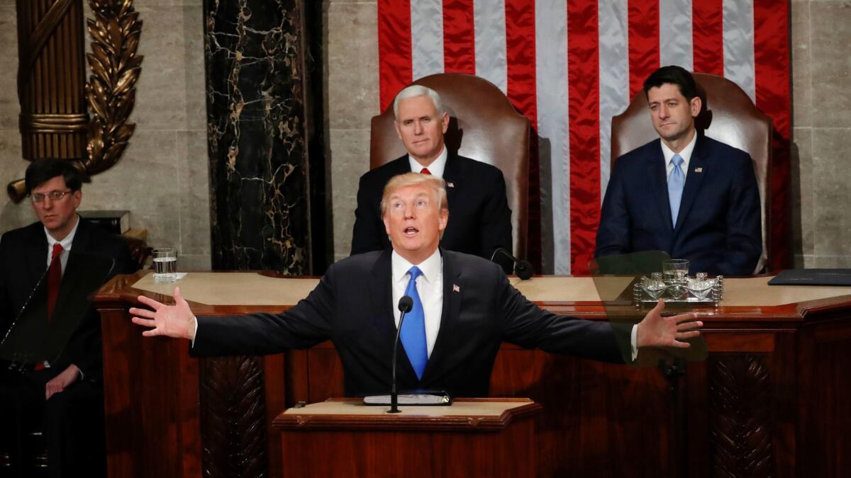 President Donald Trump delivers his 2018 State of the Union address before a joint session of Congress, as Vice President Mike Pence and House Speaker Paul Ryan look on.