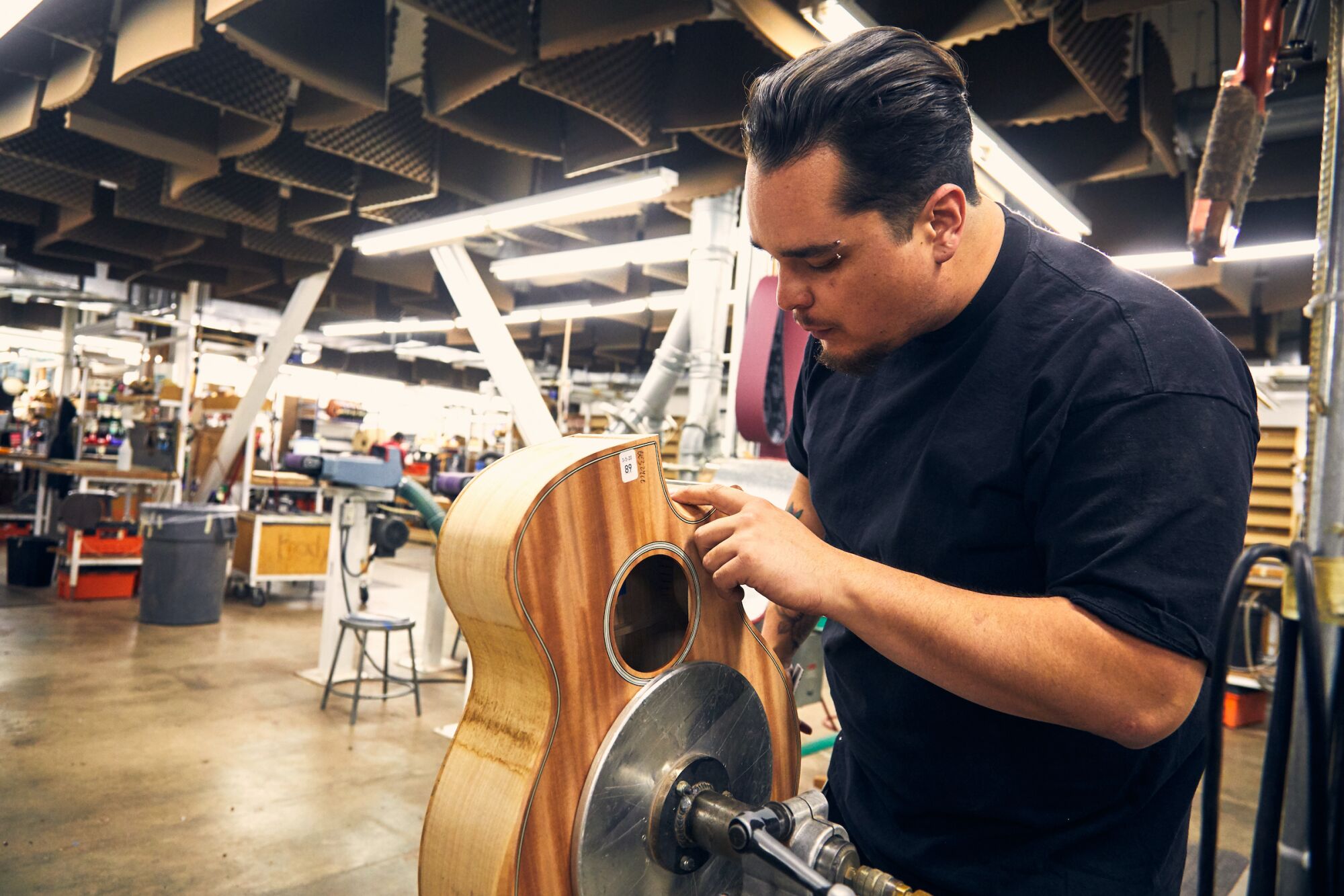 At Taylor Guitars' El Cajon facility, Clinton Jackson works on a guitar made out of urban wood.