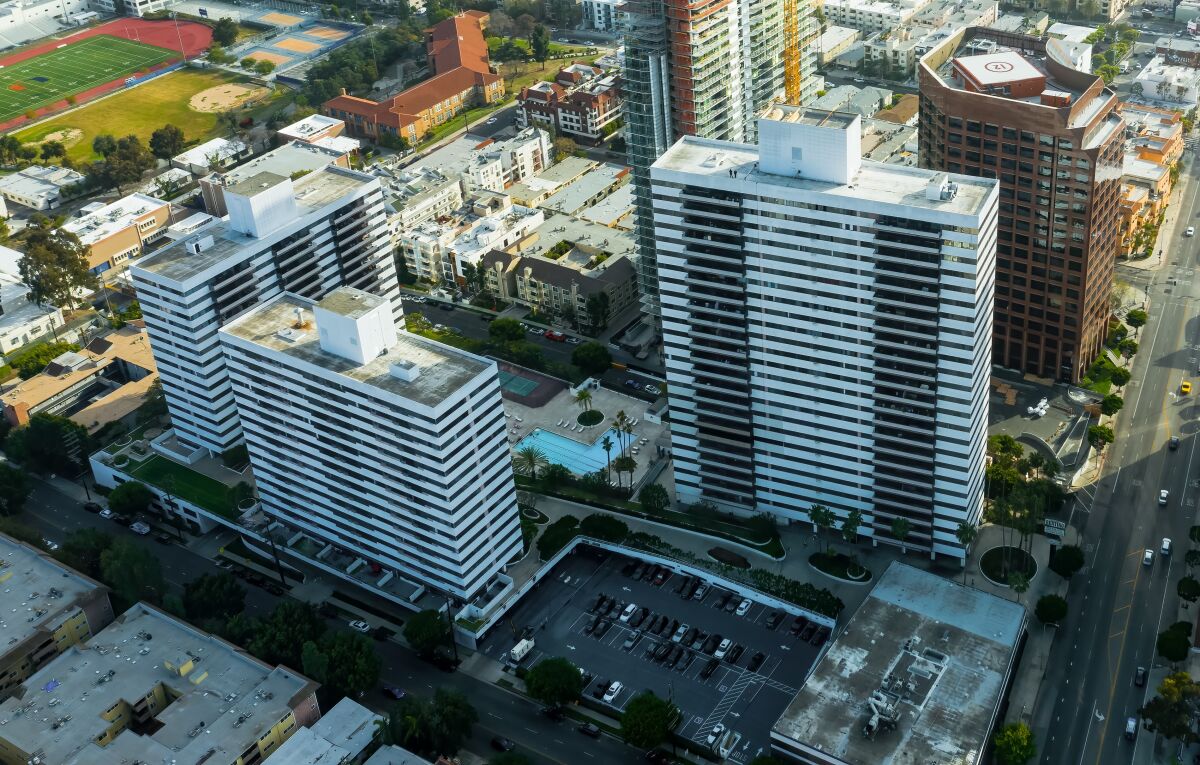 An aerial frame of a three-building apartment complex. 