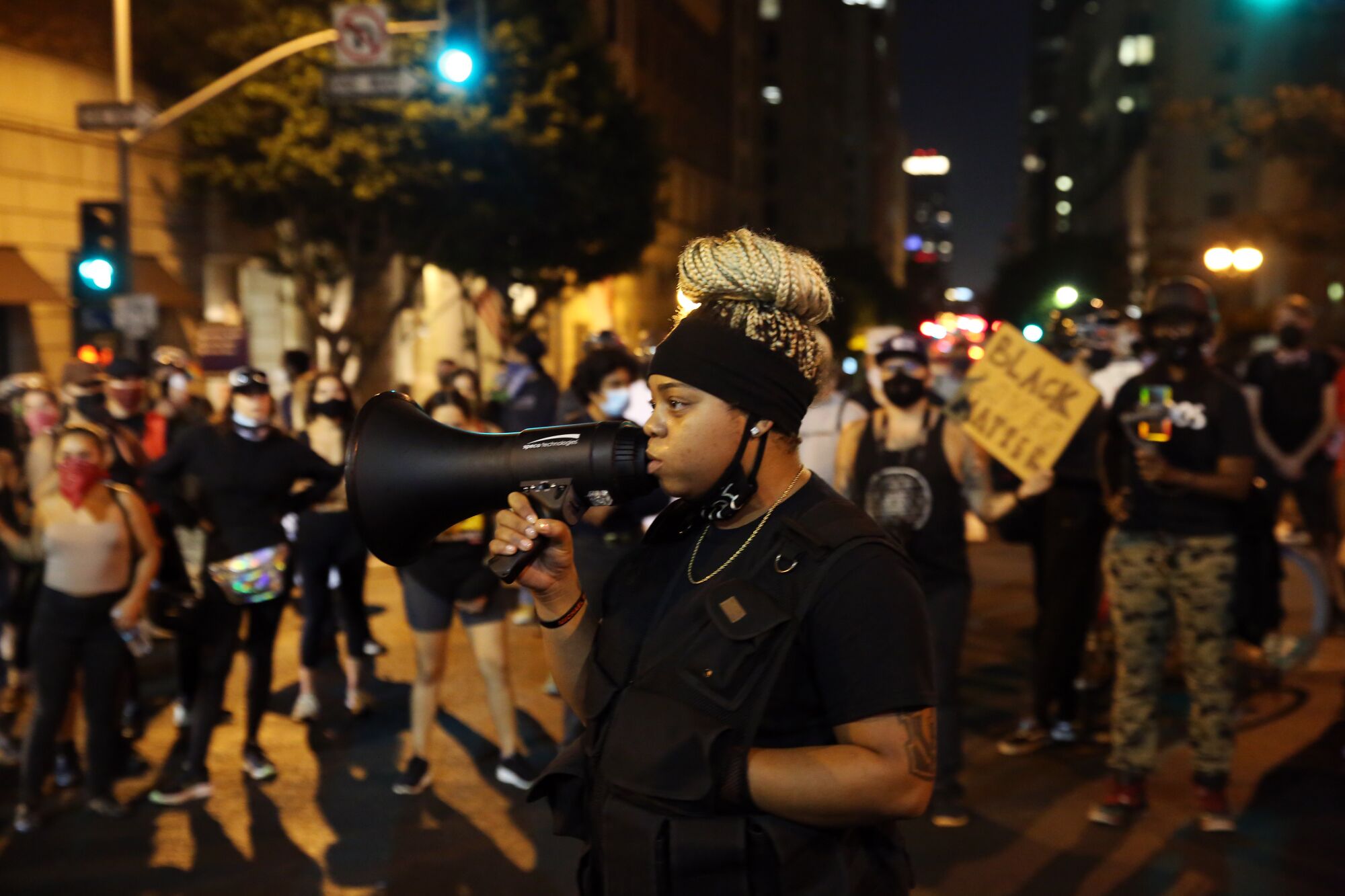 A demonstrator speaks to the crowd during a protest in downtown L.A. before entering the 3rd Street tunnel.