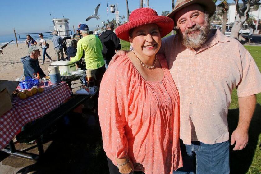 Trish and Brad Miller administer a homeless outreach breakfast on the grounds of Main Beach in Laguna, on Wednesday.
