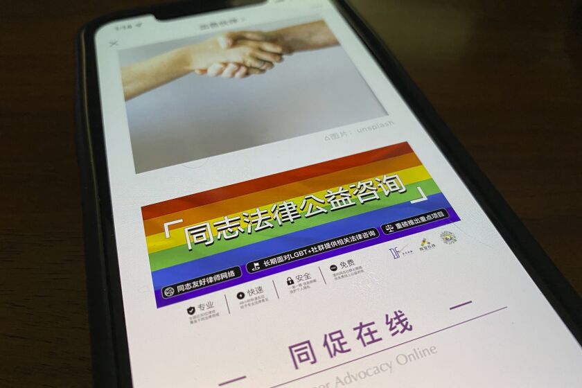 An online post about the work of the LGBT Rights Advocacy Group with a link to their social media account Queer Advocacy Online is displayed on a phone in Beijing, China, Friday, Nov. 5, 2021. The LGBT advocacy group in China that has spearheaded many of the country's legal cases pushing for greater rights, announced on social media Thursday, Nov. 5, 2021, it is halting its work for the foreseeable future. (AP Photo/Ng Han Guan)