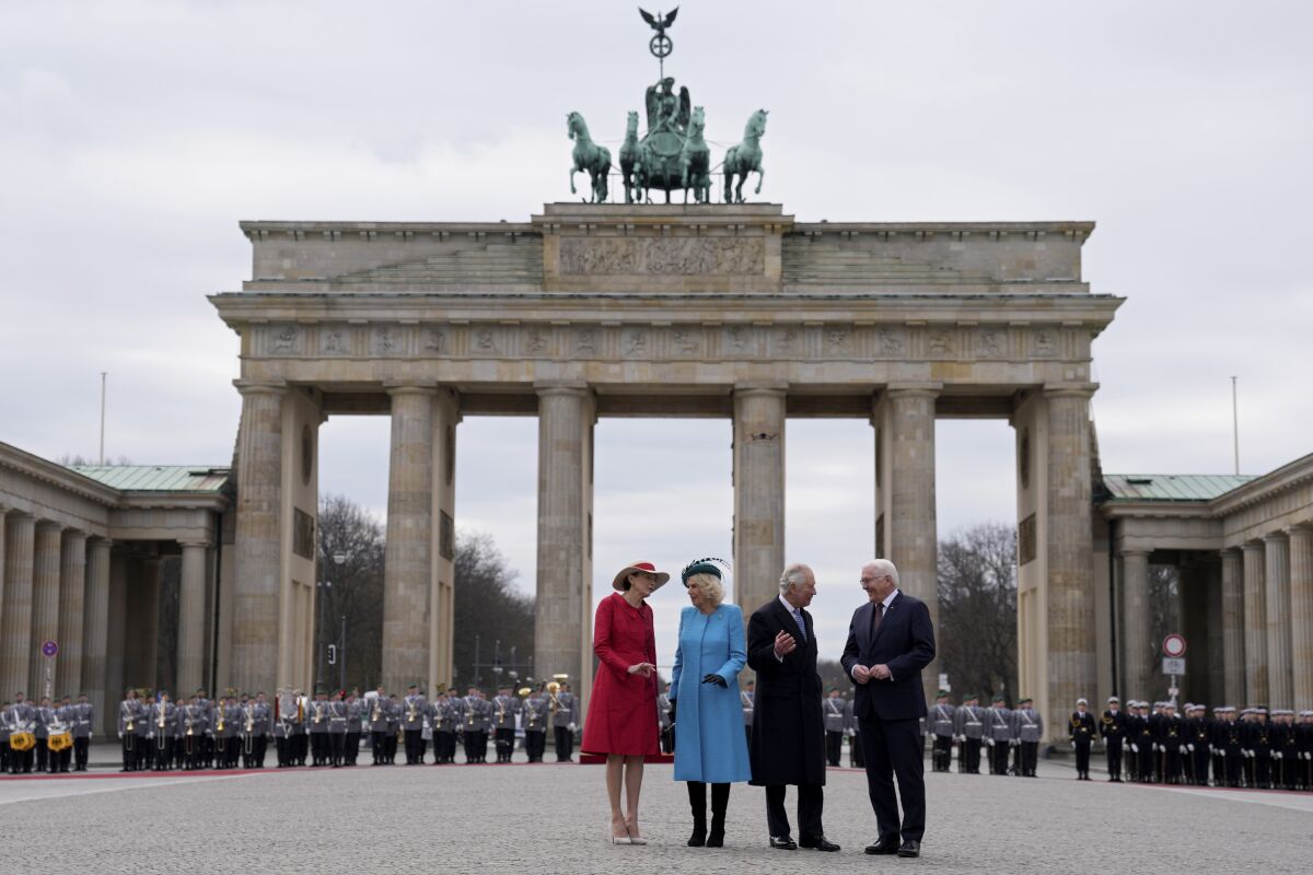 German President Frank-Walter Steinmeier, right, and his wife Elke Buedenbender, left, welcome Britain's King Charles III and Camilla, the Queen Consort, in front of the Brandenburg Gate in Berlin, Wednesday, March 29, 2023. King Charles III arrived Wednesday for a three-day official visit to Germany. (AP Photo/Matthias Schrader)