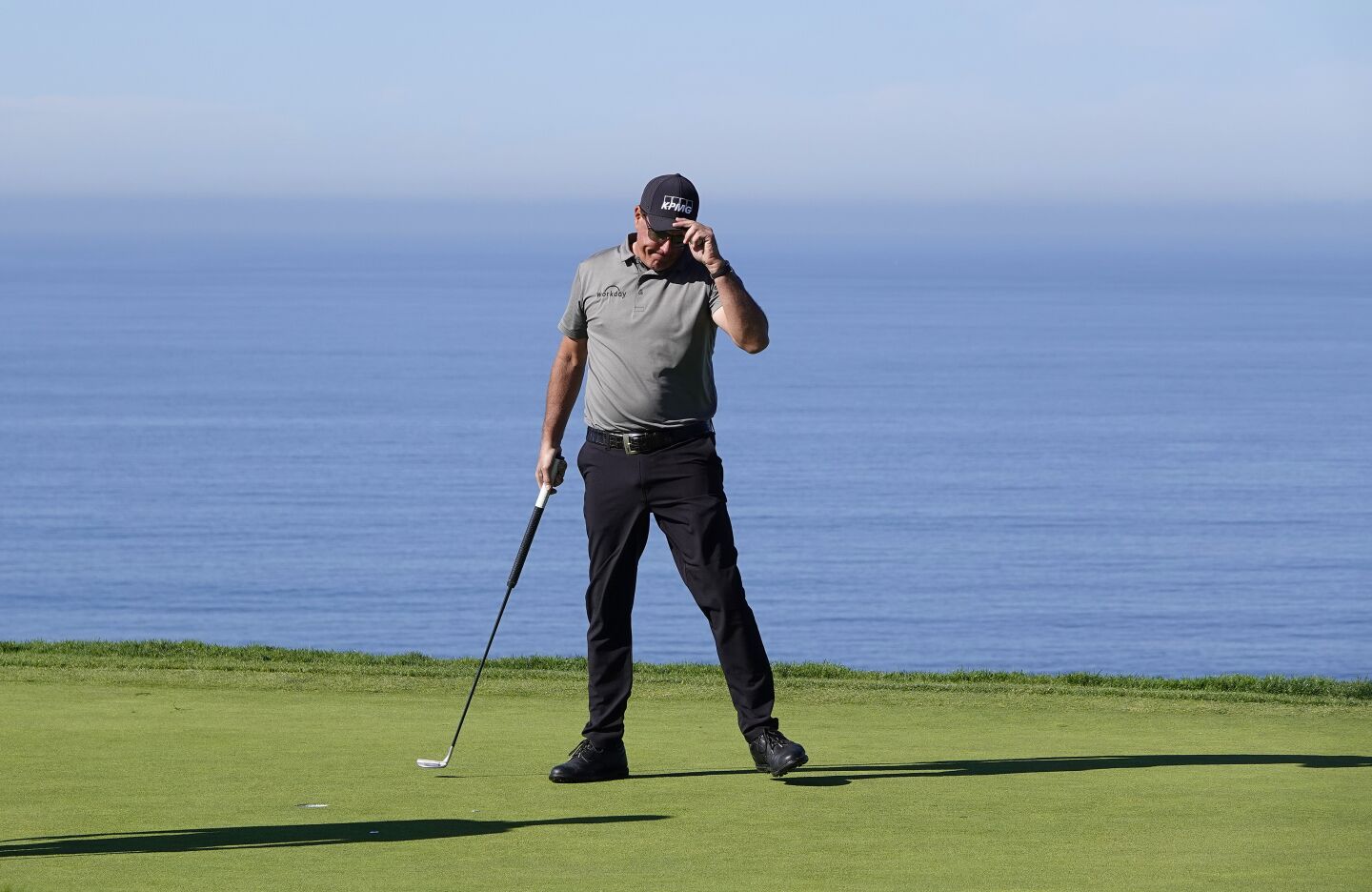 Phil Mickelson sinks a putt on the fourth hole of Torrey Pines' South Course during the first round of the Farmers Insurance Open on Jan. 26.